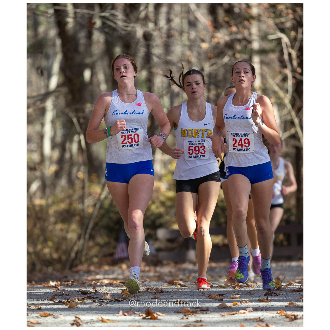 Emily Bourke, Cumberland, Abby Nicolopoulos, North Kingstown, Anna Bianchi, Cumberland at 2024 RIIL Cross Country Class Championships at Ponaganset High School, North Scituate, Rhode Island on October 26, 2024 title=