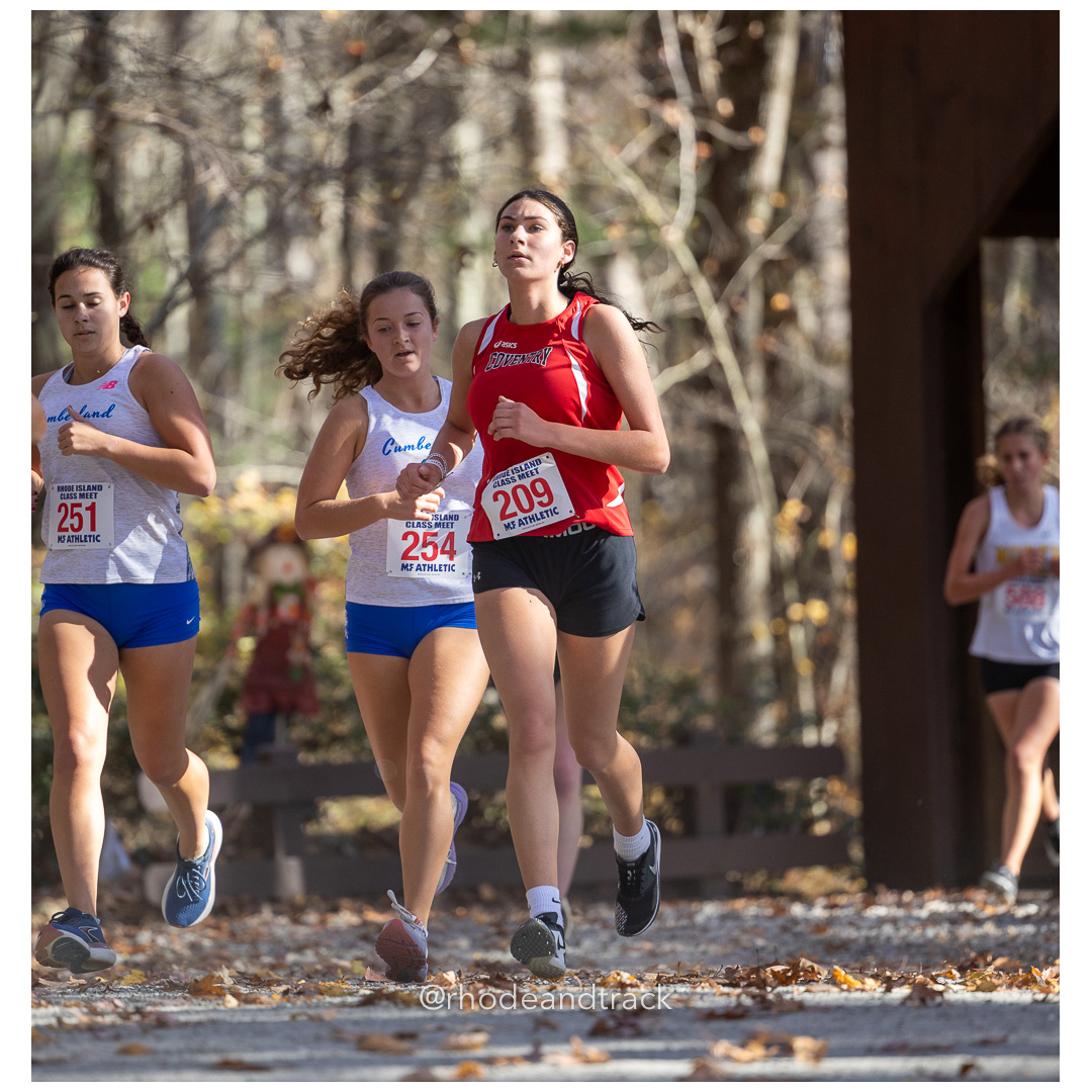 Addison Buchanan, Cumberland, Delaney Kennedy, Cumberland, Marlee Salvo, Coventry, at 2024 RIIL Cross Country Class Championships at Ponaganset High School, North Scituate, Rhode Island on October 26, 2024 title=