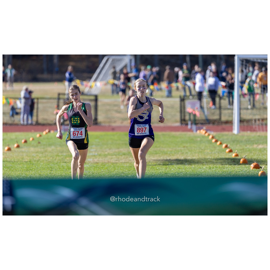 Julia Dowling, North Smithfield, Mackenzie Lickert, St. Raphael, at 2024 RIIL Cross Country Class Championships at Ponaganset High School, North Scituate, Rhode Island on October 26, 2024 title=