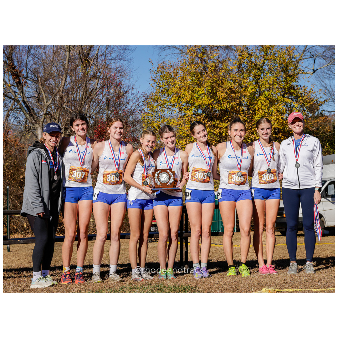 Charli McCue, Cumberland GR 11, Emily Bourke, Cumberland GR 12, Ceceila Ludwig, Cumberland GR 9, Gabby Stoothoff, Cumberland GR 10, Anna Bianchi, Cumberland GR 10, Kiley Defusco, Cumberland GR 12, Rose Tuomisto, Cumberland GR 12, Coach Kerry Carpenter at 2024 New England Cross Country Championships at Wickham Park in Manchester CT on November 9, 2024 title=