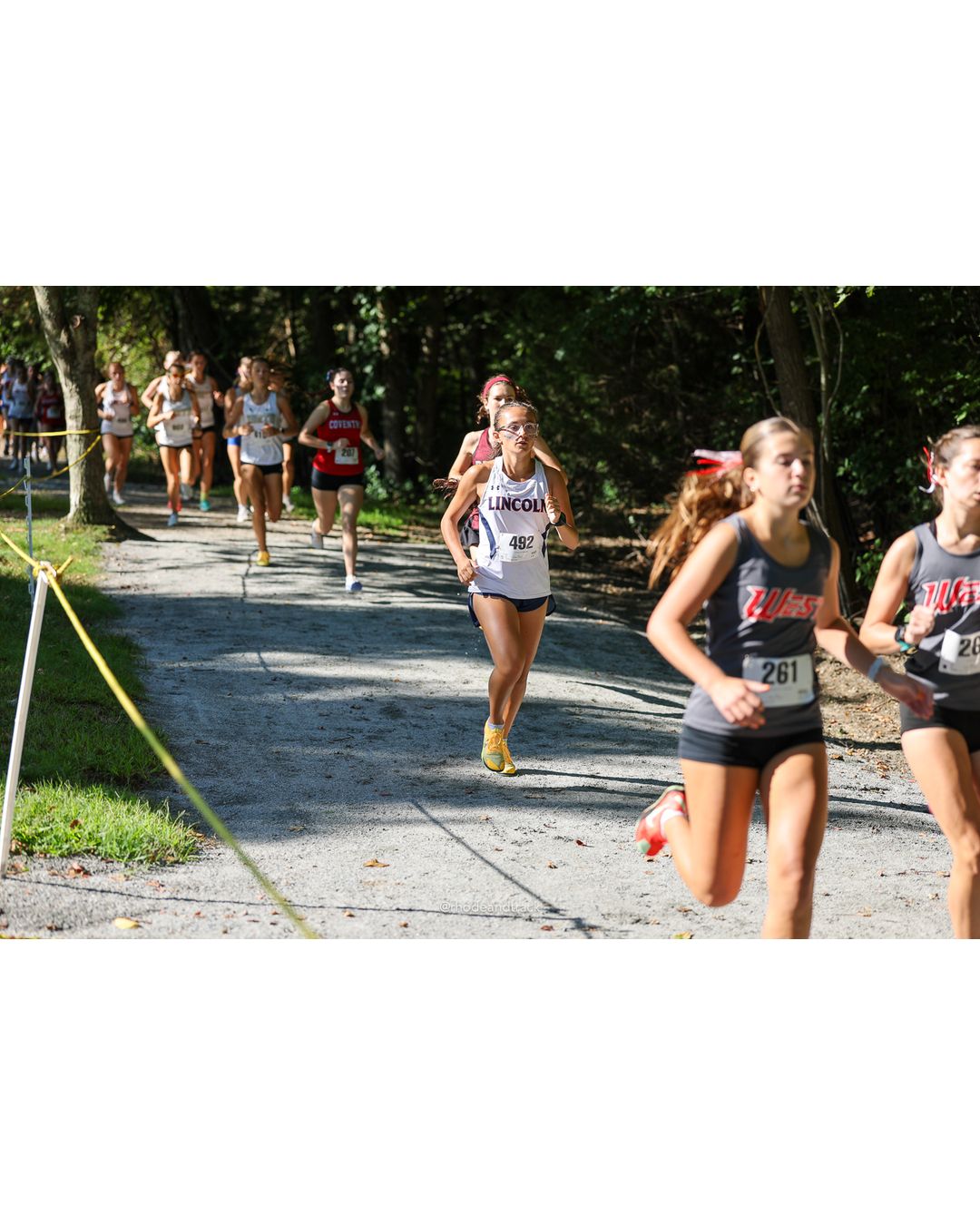 #261 Isla Tucciarone, Cranston West HS, 5k Run - Girls (Roy), P18, 22:33.91; #492 Sophia DeSimone, Lincoln High School, 5k Run - Girls (Roy), P13, 21:47.37 - #261 Isla Tucciarone, Cranston West HS, 5k Run - Girls (Roy), P18, 22:33.91; #492 Sophia DeSimone, Lincoln High School, 5k Run - Girls (Roy), P13, 21:47.37 - 2026 Injury Fund Carnival XC - Deerfield Park - Greenville, Rhode Island - September 05, 2026 File: ./dir-2-5k_Run-Girls-Roy/260905-2026-injury-fund-xc-deerfield-park-181-398A5118.jpg #261 Isla Tucciarone, Cranston West HS, 5k Run - Girls (Roy), P18, 22:33.91; #492 Sophia DeSimone, Lincoln High School, 5k Run - Girls (Roy…