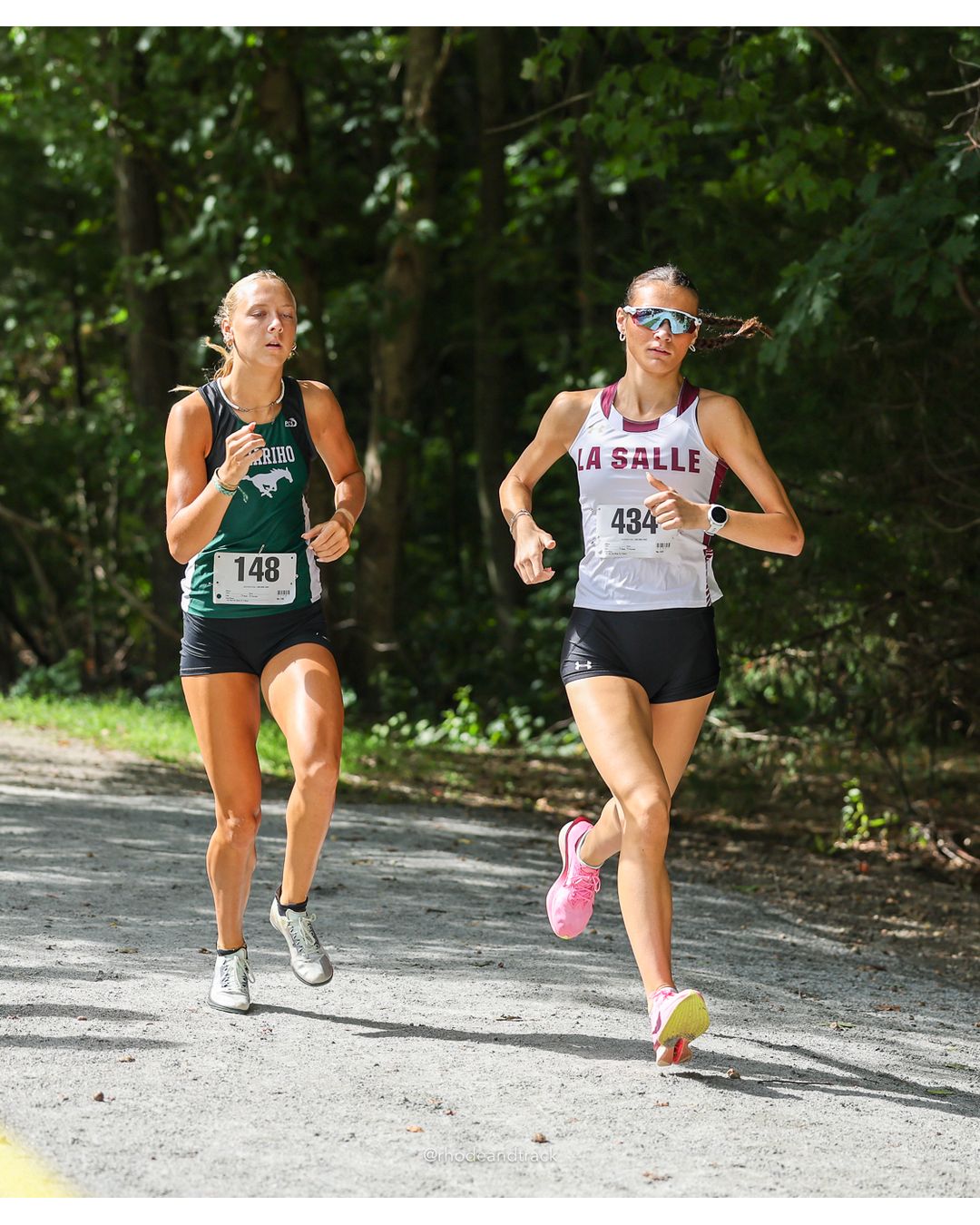 #148 Meriden Alge, Chariho High School, 5k Run - Girls (Hindley), P2, 19:53.00; #434 Alyssa Parenteau, La Salle Academy, 5k Run - Girls (Hindley), P1, 19:17.34 - #148 Meriden Alge, Chariho High School, 5k Run - Girls (Hindley), P2, 19:53.00; #434 Alyssa Parenteau, La Salle Academy, 5k Run - Girls (Hindley), P1, 19:17.34 - 2026 Injury Fund Carnival XC - Deerfield Park - Greenville, Rhode Island - September 05, 2026 File: ./dir-4-5k_Run-Girls-Hindley/260905-2026-injury-fund-xc-deerfield-park-516-398A9696.jpg #148 Meriden Alge, Chariho High School, 5k Run - Girls (Hindley), P2, 19:53.00; #434 Alyssa Parenteau, La Salle Academy, 5k Run - Girls (Hi…