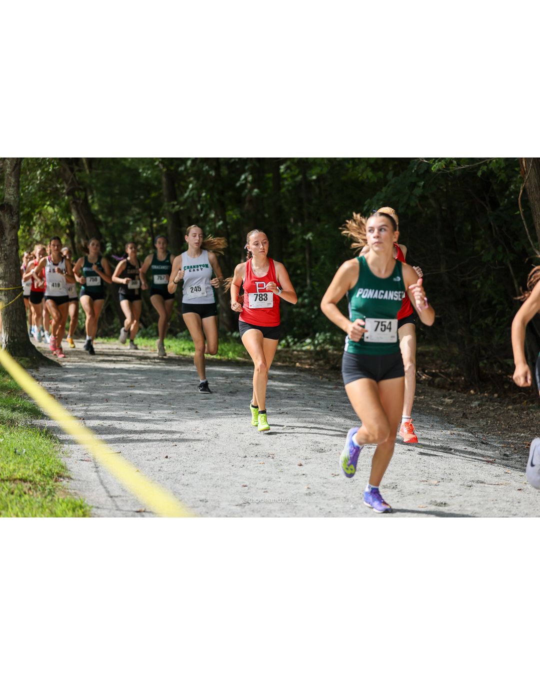 #754 Madison Ourique, Ponaganset High School, 5k Run - Girls (Hindley), P10, 21:55.46; #245 Winnie White, Cranston East High School, 5k Run - Girls (Hindley), P12, 22:33.98 - #754 Madison Ourique, Ponaganset High School, 5k Run - Girls (Hindley), P10, 21:55.46; #783 Sara Higgins, Portsmouth High School, 5k Run - Girls (Hindley), P16, 23:17.76; #245 Winnie White, Cranston East High School, 5k Run - Girls (Hindley), P12, 22:33.98 - 2026 Injury Fund Carnival XC - Deerfield Park - Greenville, Rhode Island - September 05, 2026 File: ./dir-4-5k_Run-Girls-Hindley/260905-2026-injury-fund-xc-deerfield-park-522-398A9858.jpg #754 Madison Ourique, Ponaganset High School, 5k Run - Girls (Hindley), P10, 21:55.46; #245 Winnie White, Cranston East High School, 5k Run…