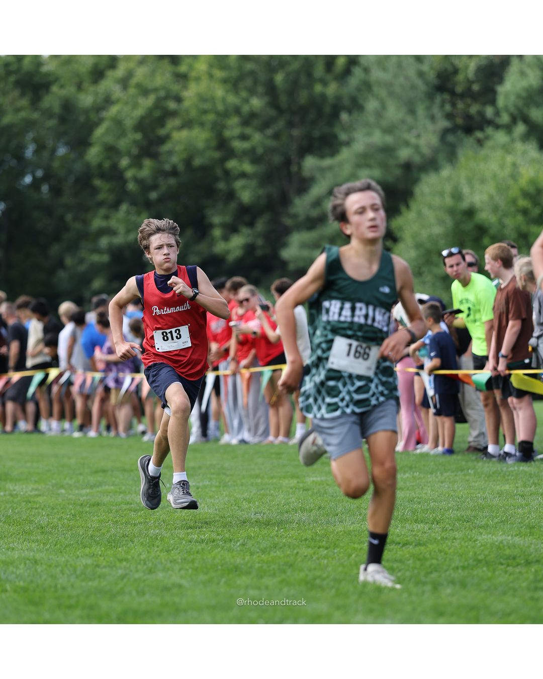 #166 Lucas Lindsay, Chariho High School, 4k Run - Boys (Dwyer), P40, 17:47.58; #813 Emmett Washburn, Portsmouth High School, 4k Run - Boys (Dwyer), P42, 17:49.19 - #166 Lucas Lindsay, Chariho High School, 4k Run - Boys (Dwyer), P40, 17:47.58; #813 Emmett Washburn, Portsmouth High School, 4k Run - Boys (Dwyer), P42, 17:49.19 - 2026 Injury Fund Carnival XC - Deerfield Park - Greenville, Rhode Island - September 05, 2026 File: ./dir-5-4k_Run-Boys-Dwyer/260905-2026-injury-fund-xc-deerfield-park-835-398A4240.jpg #166 Lucas Lindsay, Chariho High School, 4k Run - Boys (Dwyer), P40, 17:47.58; #813 Emmett Washburn, Portsmouth High School, 4k Run - Boys…