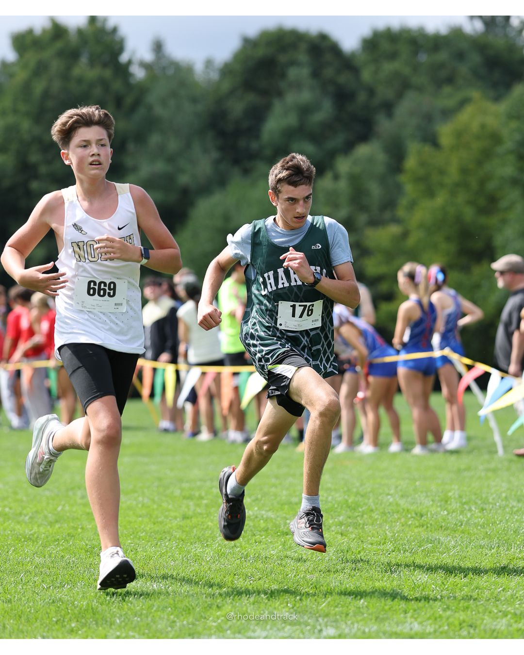 #669 Tyler Parkhurst, North Kingstown High School, 4k Run - Boys (Dwyer), P75, 19:14.44; #176 Kalaeb Simone, Chariho High School, 4k Run - Boys (Dwyer), P74, 19:13.48 - #176 Kalaeb Simone, Chariho High School, 4k Run - Boys (Dwyer), P74, 19:13.48 - 2026 Injury Fund Carnival XC - Deerfield Park - Greenville, Rhode Island - September 05, 2026 File: ./dir-5-4k_Run-Boys-Dwyer/260905-2026-injury-fund-xc-deerfield-park-869-398A4712.jpg #669 Tyler Parkhurst, North Kingstown High School, 4k Run - Boys (Dwyer), P75, 19:14.44; #176 Kalaeb Simone, Chariho High School, 4k Run -…