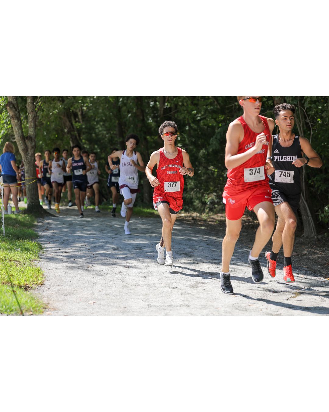 #374 Cormac Moran, East Providence High School, 5k Run - Boys (Myers), P13, 18:19.69; #745 Matt Tessier, Pilgrim High School, 5k Run - Boys (Myers), P51, 20:29.11; #377 Luca Raposo, East Providence High School, 5k Run - Boys (Myers), P35, 19:43.69 - #374 Cormac Moran, East Providence High School, 5k Run - Boys (Myers), P13, 18:19.69; #745 Matt Tessier, Pilgrim High School, 5k Run - Boys (Myers), P51, 20:29.11; #377 Luca Raposo, East Providence High School, 5k Run - Boys (Myers), P35, 19:43.69 - 2026 Injury Fund Carnival XC - Deerfield Park - Greenville, Rhode Island - September 05, 2026 File: ./dir-7-5k_Run-Boys-Myers/260905-2026-injury-fund-xc-deerfield-park-1073-398A7350.jpg #374 Cormac Moran, East Providence High School, 5k Run - Boys (Myers), P13, 18:19.69; #745 Matt Tessier, Pilgrim High School, 5k Run - Boys…