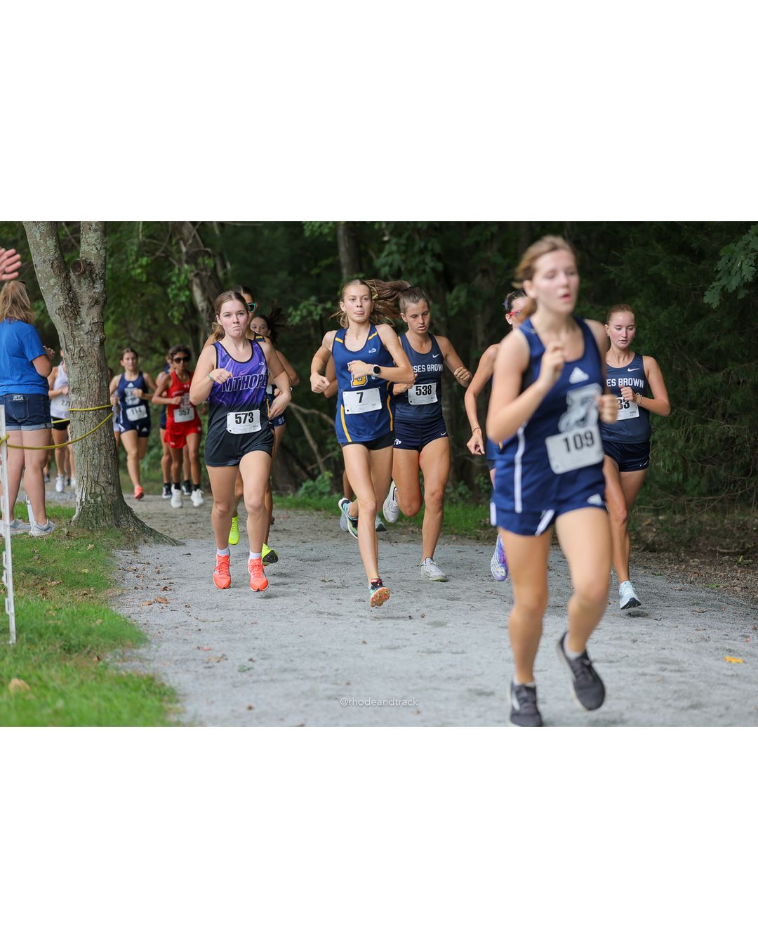 #109 Ellie Gobin, Burrillville High School, 5k Run - Girls (Caswell), P25, 24:18.33; #573 Evelyn Towers, Mount Hope High School, 5k Run - Girls (Caswell), P21, 23:19.09; #538 Edie Lane, Moses Brown School, 5k Run - Girls (Caswell), P10, 21:51.02 - #109 Ellie Gobin, Burrillville High School, 5k Run - Girls (Caswell), P25, 24:18.33; #573 Evelyn Towers, Mount Hope High School, 5k Run - Girls (Caswell), P21, 23:19.09; #538 Edie Lane, Moses Brown School, 5k Run - Girls (Caswell), P10, 21:51.02 - 2026 Injury Fund Carnival XC - Deerfield Park - Greenville, Rhode Island - September 05, 2026 File: ./dir-8-5k_Run-Girls-Caswell/260905-2026-injury-fund-xc-deerfield-park-1286-398A0974.jpg #109 Ellie Gobin, Burrillville High School, 5k Run - Girls (Caswell), P25, 24:18.33; #573 Evelyn Towers, Mount Hope High School, 5k Run - G…