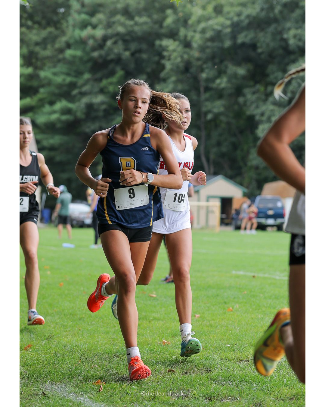 #104 Keira Closter, Block Island High School, 5k Run - Girls (Caswell), P3, 19:15.65; #9 Carly Gill, Barrington High School, 5k Run - Girls (Caswell), P1, 18:46.12 - 2026 Injury Fund Carnival XC - Deerfield Park - Greenville, Rhode Island - September 05, 2026 File: ./dir-8-5k_Run-Girls-Caswell/260905-2026-injury-fund-xc-deerfield-park-1333-398A1280.jpg #104 Keira Closter, Block Island High School, 5k Run - Girls (Caswell), P3, 19:15.65; #9 Carly Gill, Barrington High School, 5k Run - Girls…