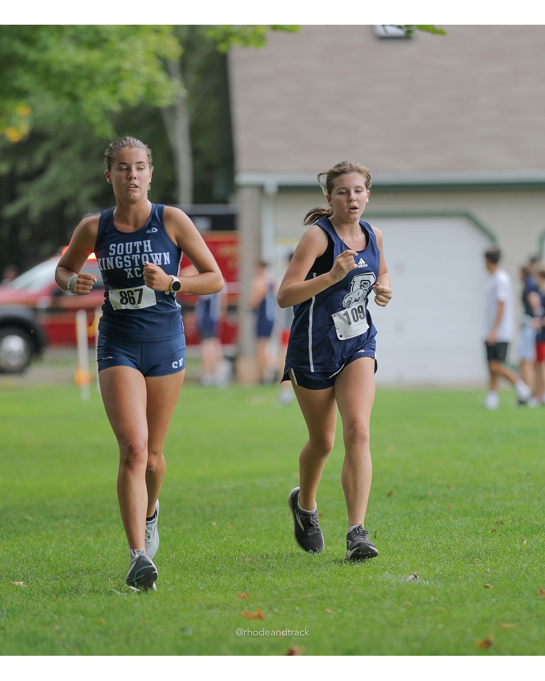 #867 Mary Guidera, South Kingstown High School, 5k Run - Girls (Caswell), P24, 23:42.57 - #109 Ellie Gobin, Burrillville High School, 5k Run - Girls (Caswell), P25, 24:18.33; #867 Mary Guidera, South Kingstown High School, 5k Run - Girls (Caswell), P24, 23:42.57 - 2026 Injury Fund Carnival XC - Deerfield Park - Greenville, Rhode Island - September 05, 2026 File: ./dir-8-5k_Run-Girls-Caswell/260905-2026-injury-fund-xc-deerfield-park-1352-398A1657_1.jpg #867 Mary Guidera, South Kingstown High School, 5k Run - Girls (Caswell), P24, 23:42.57 - #109 Ellie Gobin, Burrillville High School, 5k Ru…