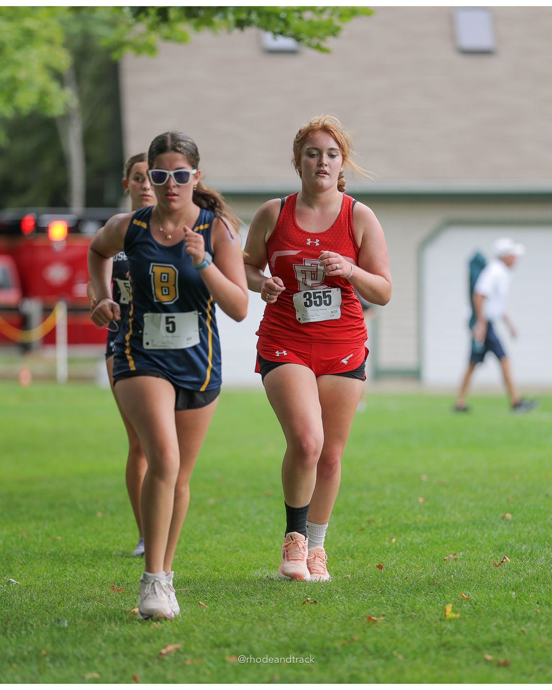 #19 Rose Rakeman, Barrington High School, 5k Run - Girls (Caswell), P30, 25:10.05; #5 Mila Djuranovic, Barrington High School, 5k Run - Girls (Caswell), P57, 31:06.51 - #355 Sophie Olive, East Providence High School, 5k Run - Girls (Caswell), P51, 29:02.94; #5 Mila Djuranovic, Barrington High School, 5k Run - Girls (Caswell), P57, 31:06.51 - 2026 Injury Fund Carnival XC - Deerfield Park - Greenville, Rhode Island - September 05, 2026 File: ./dir-8-5k_Run-Girls-Caswell/260905-2026-injury-fund-xc-deerfield-park-1383-398A2056.jpg #19 Rose Rakeman, Barrington High School, 5k Run - Girls (Caswell), P30, 25:10.05; #5 Mila Djuranovic, Barrington High School, 5k Run - Gir…