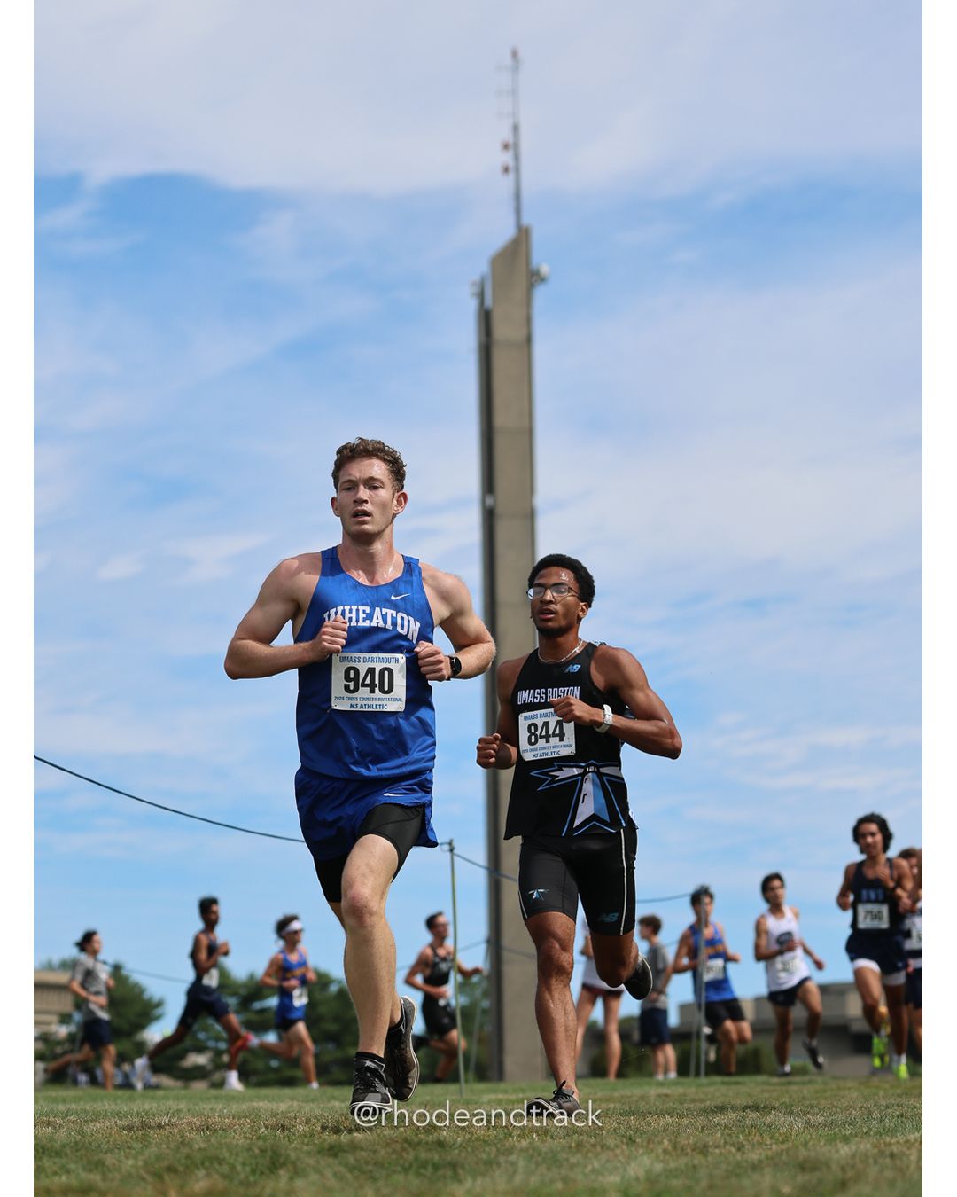 #940 Finn Morris, Wheaton (Mass.), 8k Run - Men (Gold-35:cap), P160, 28:06.34; #844 Jayden Ferreras, UMass Boston, 8k Run - Men (Gold-35:cap), P201, 29:36.64 - 2026 UMass Dartmouth XC Invitational - UMass Dartmouth - Dartmouth, Massachusetts - September 19, 2026 File: ./260919-2026-UMass-Dartmouth-XC-Invitational-200-398A7123.jpg #940 Finn Morris, Wheaton (Mass.), 8k Run - Men (Gold-35:cap), P160, 28:06.34; #844 Jayden Ferreras, UMass Boston, 8k Run - Men (Gold-35:ca…