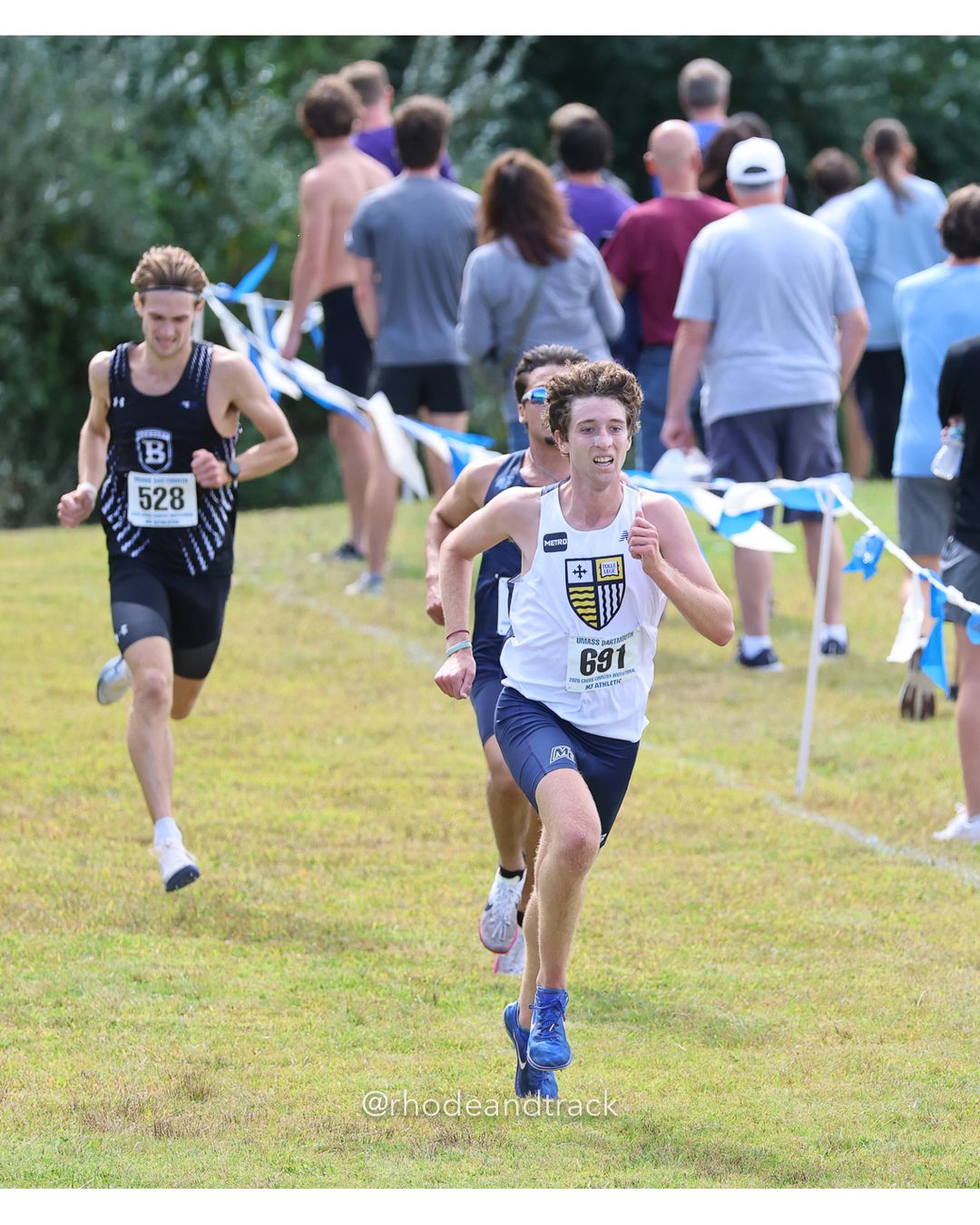 #691 Aidan Dupill, Merrimack, 8k Run - Men (Gold-35:cap), P4, 24:39.24; #528 Hayden MacArthur, Bentley, 8k Run - Men (Gold-35:cap), P5, 24:39.32 - 2026 UMass Dartmouth XC Invitational - UMass Dartmouth - Dartmouth, Massachusetts - September 19, 2026 File: ./260919-2026-UMass-Dartmouth-XC-Invitational-343-398A9934.jpg #691 Aidan Dupill, Merrimack, 8k Run - Men (Gold-35:cap), P4, 24:39.24; #528 Hayden MacArthur, Bentley, 8k Run - Men (Gold-35:cap), P5, 24:…