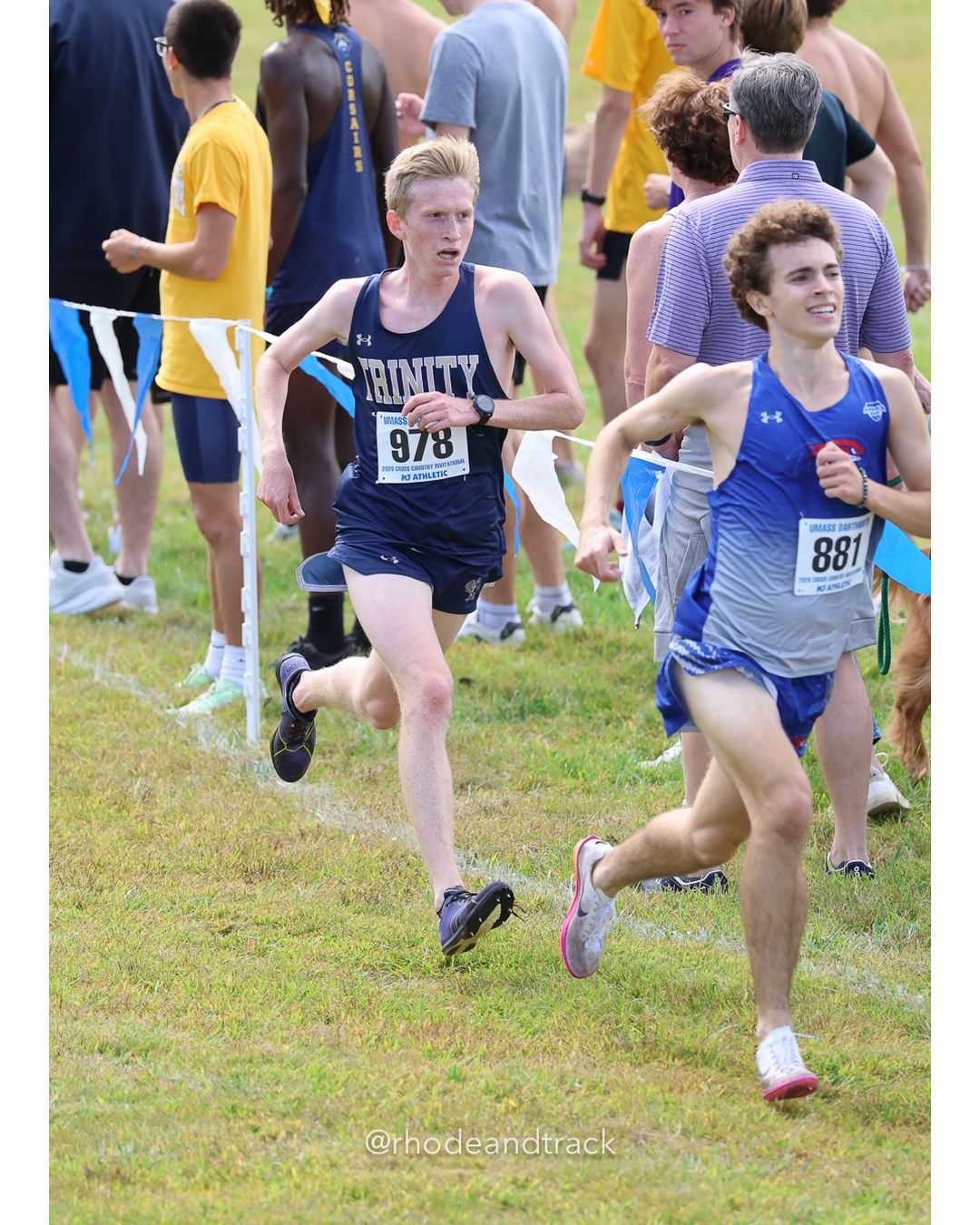 #978 Lysander Duffield, Trinity (Conn.), 8k Run - Men (Gold-35:cap), P26, 25:24.34; #881 Patrick Hall, UMass Lowell, 8k Run - Men (Gold-35:cap), P25, 25:23.53 - 2026 UMass Dartmouth XC Invitational - UMass Dartmouth - Dartmouth, Massachusetts - September 19, 2026 File: ./260919-2026-UMass-Dartmouth-XC-Invitational-362-398A0370.jpg #978 Lysander Duffield, Trinity (Conn.), 8k Run - Men (Gold-35:cap), P26, 25:24.34; #881 Patrick Hall, UMass Lowell, 8k Run - Men (Gold-35:…