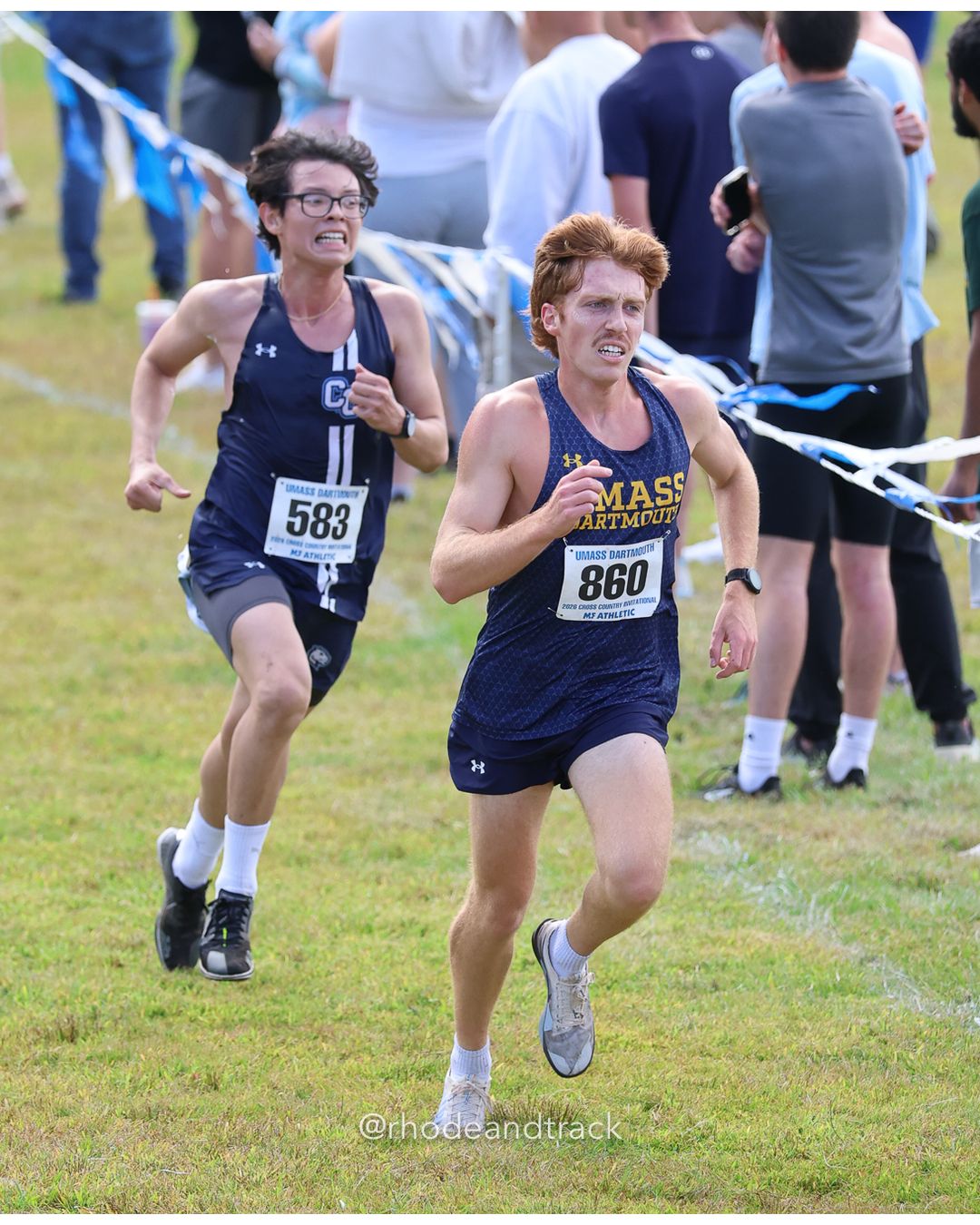 #860 Colin Ozturk, UMass Dartmouth, 8k Run - Men (Gold-35:cap), P106, 26:53.35; #583 Alex Santos-Acosta, Connecticut College, 8k Run - Men (Gold-35:cap), P103, 26:52.26 - 2026 UMass Dartmouth XC Invitational - UMass Dartmouth - Dartmouth, Massachusetts - September 19, 2026 File: ./260919-2026-UMass-Dartmouth-XC-Invitational-429-398A1553.jpg #860 Colin Ozturk, UMass Dartmouth, 8k Run - Men (Gold-35:cap), P106, 26:53.35; #583 Alex Santos-Acosta, Connecticut College, 8k Run - Men…