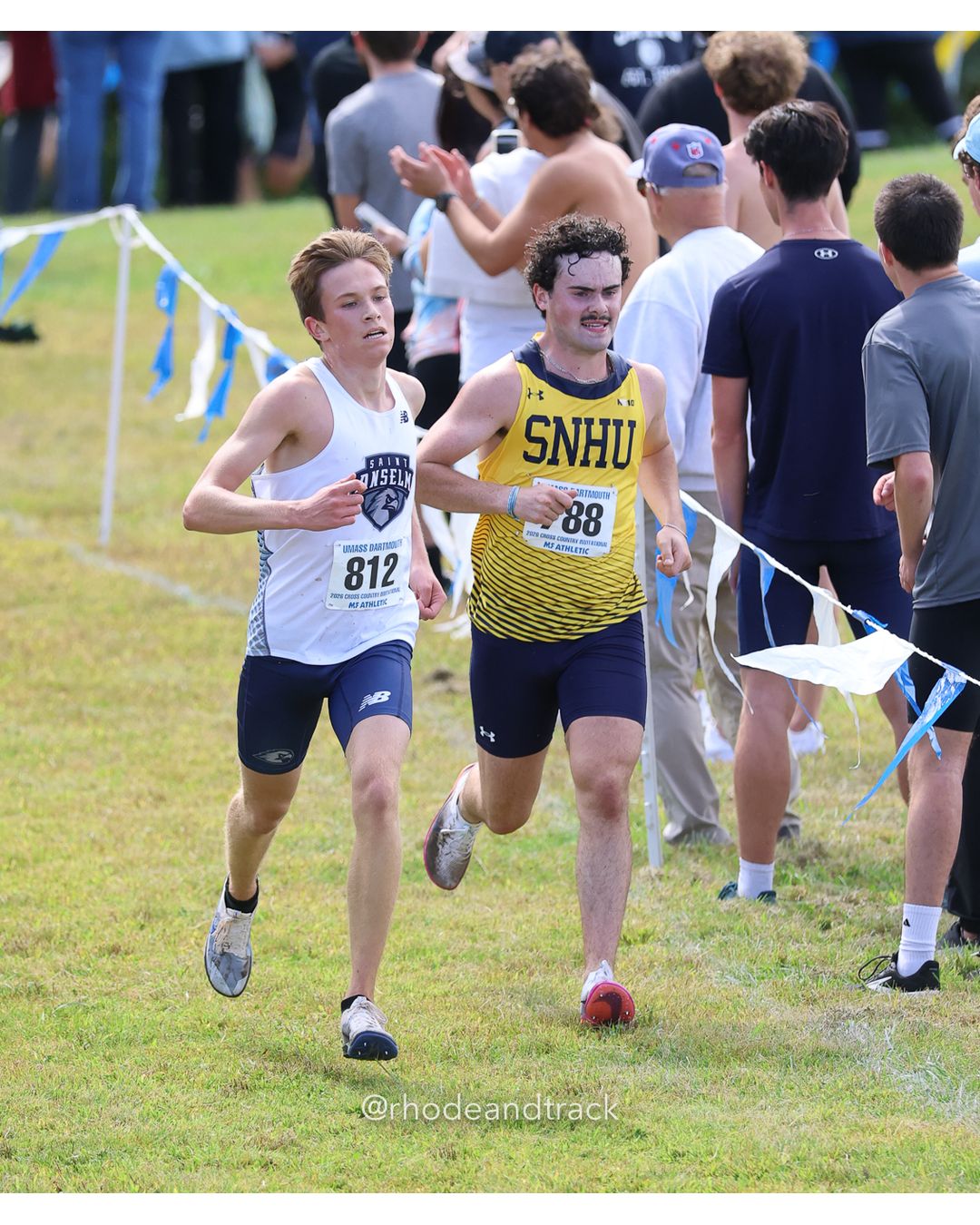 #812 William Oldham, St. Anselm, 8k Run - Men (Gold-35:cap), P139, 27:39.14; #88 Greta Schmitt, Connecticut College, 6k Run - Women (Navy-45:cap), P73, 25:49.44 - 2026 UMass Dartmouth XC Invitational - UMass Dartmouth - Dartmouth, Massachusetts - September 19, 2026 File: ./260919-2026-UMass-Dartmouth-XC-Invitational-456-398A2156.jpg #812 William Oldham, St. Anselm, 8k Run - Men (Gold-35:cap), P139, 27:39.14; #88 Greta Schmitt, Connecticut College, 6k Run - Women (Navy-4…